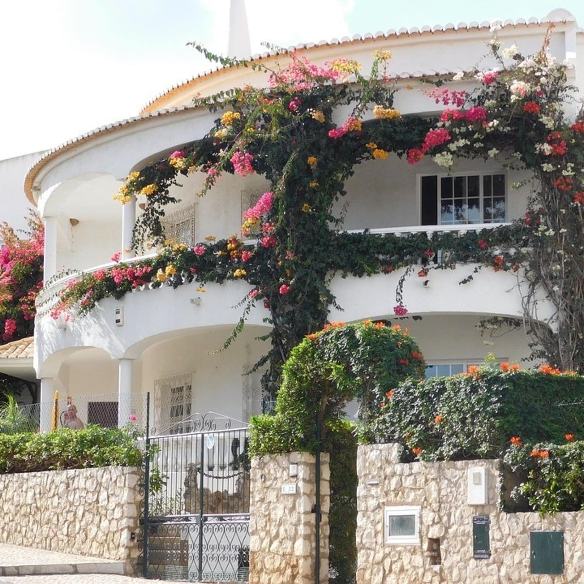Blumenbewachsene Finca in Portugal mit Steinmauer